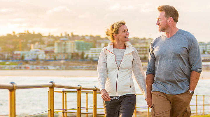 Happy man and woman walking near the bay